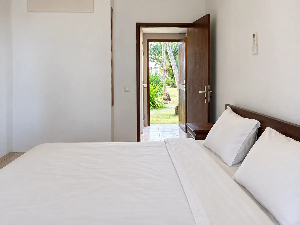 The deluxe double: a double bed, the door open onto the garden.